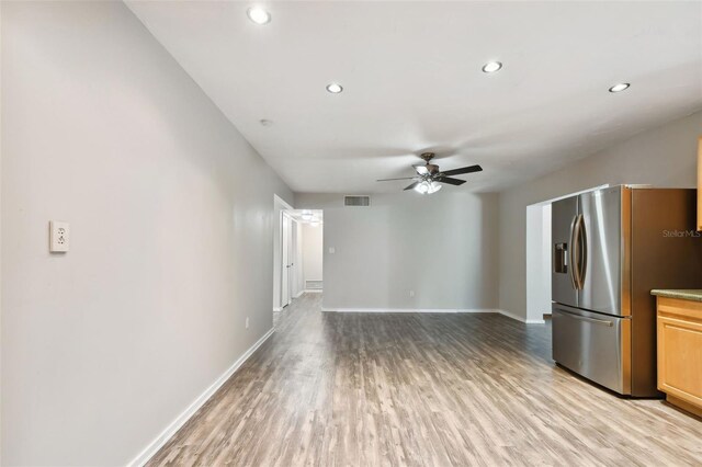 kitchen featuring ceiling fan, light wood-type flooring, and stainless steel fridge