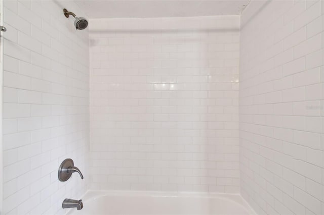 interior details with tiled shower / bath combo