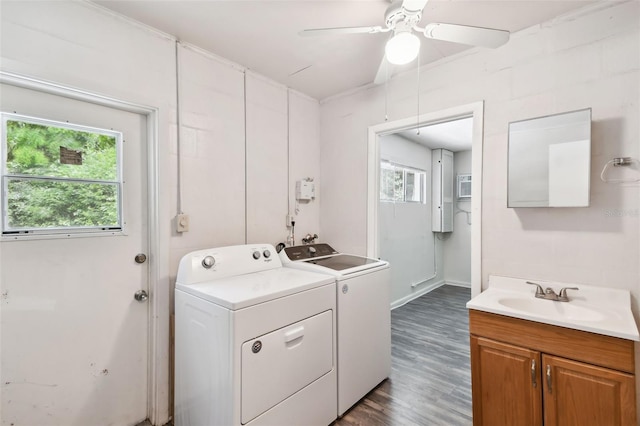 clothes washing area with ceiling fan, sink, washing machine and clothes dryer, and dark hardwood / wood-style flooring