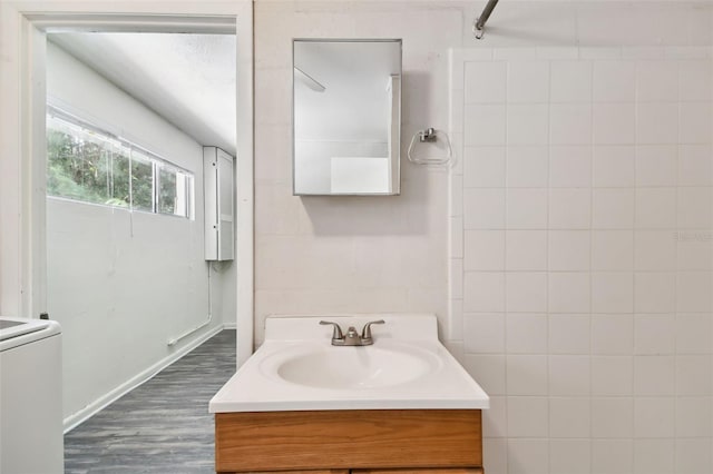 bathroom featuring tile walls, vanity, and wood-type flooring