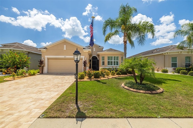 view of front of property with a garage and a front lawn