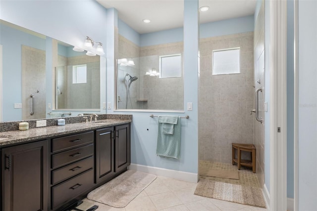 bathroom featuring vanity, tile patterned flooring, and a shower with shower door