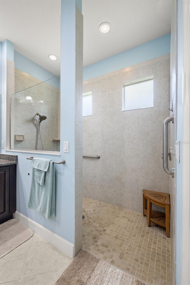 bathroom with vanity, walk in shower, and tile patterned flooring