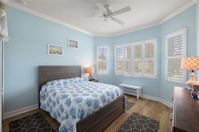 bedroom with ceiling fan, hardwood / wood-style flooring, and ornamental molding