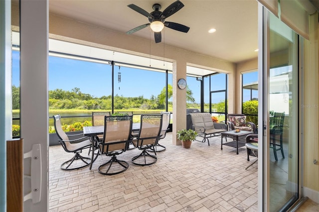 sunroom featuring ceiling fan