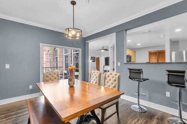 dining area with crown molding, dark hardwood / wood-style floors, and ceiling fan