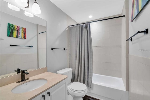 full bathroom with tile walls, toilet, shower / bath combo with shower curtain, and vanity