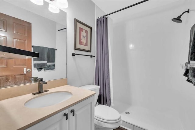 bathroom with vanity, toilet, and a shower with shower curtain