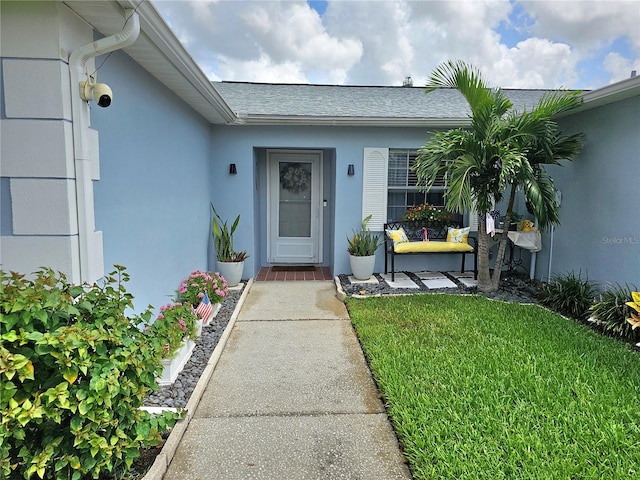 property entrance with a yard