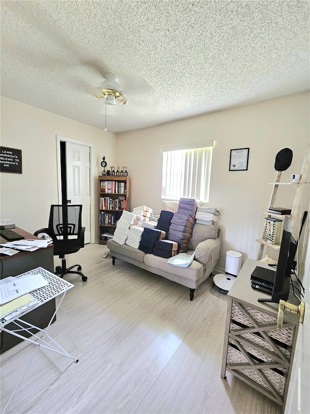 living room featuring a textured ceiling and light hardwood / wood-style flooring