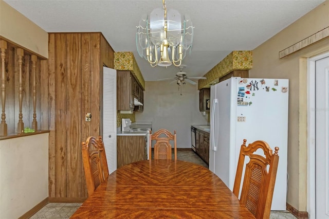 tiled dining space featuring ceiling fan with notable chandelier