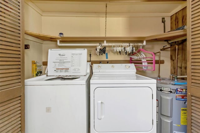 laundry room with electric water heater and washing machine and clothes dryer