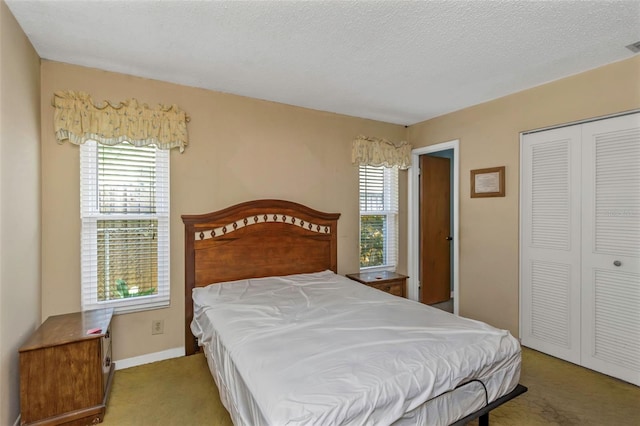 bedroom with a textured ceiling and a closet