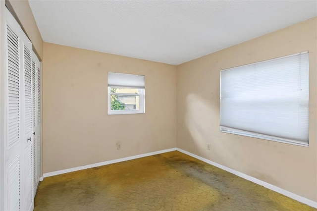 unfurnished bedroom featuring a closet and carpet floors