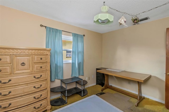 miscellaneous room featuring a textured ceiling and carpet floors