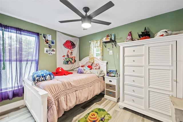 bedroom with light wood finished floors and ceiling fan