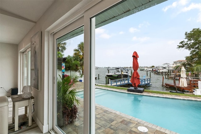 view of pool featuring a dock and a water view