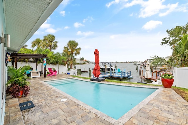 pool with a water view, a boat dock, a fenced backyard, boat lift, and a patio area