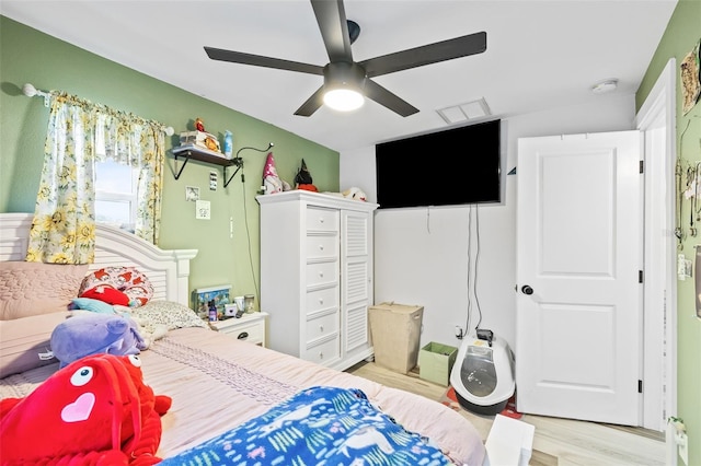 bedroom with ceiling fan and light hardwood / wood-style floors