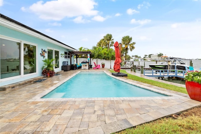 pool with a patio area, a boat dock, and a pergola