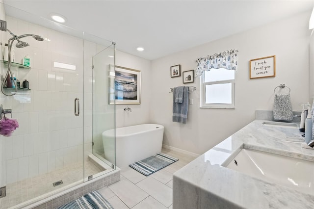 bathroom featuring tile patterned flooring, a shower stall, a freestanding tub, and a sink