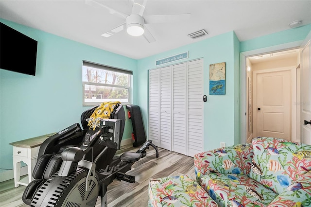 playroom featuring a ceiling fan, visible vents, and light wood-type flooring