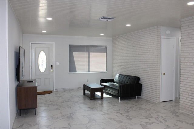 entrance foyer featuring tile patterned floors and brick wall