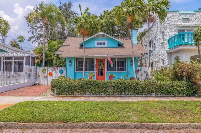 view of front of house featuring a balcony and a front yard