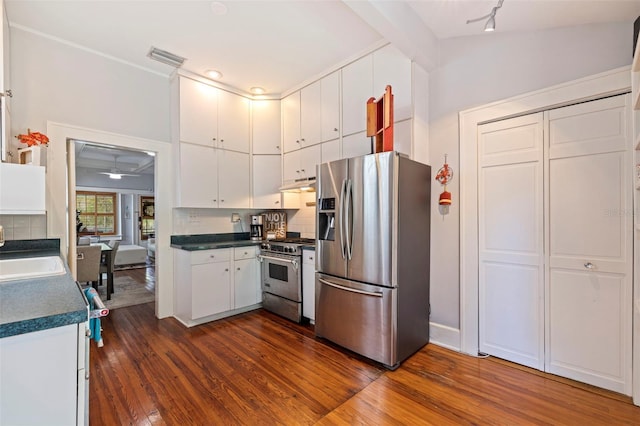 kitchen featuring decorative backsplash, white cabinetry, dark hardwood / wood-style flooring, and stainless steel appliances