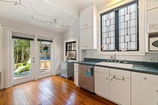 kitchen with white cabinets, lofted ceiling with beams, dark hardwood / wood-style flooring, and stainless steel dishwasher