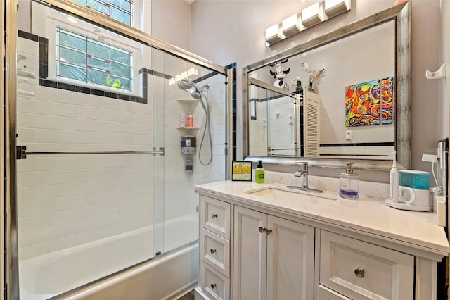 bathroom with vanity and bath / shower combo with glass door