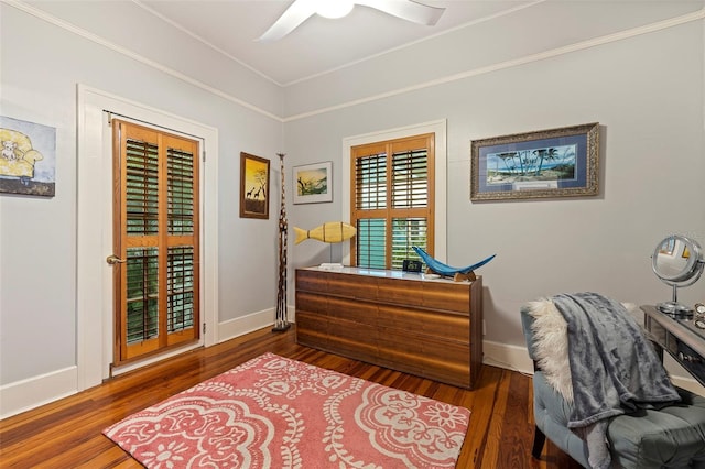 office area with baseboards, wood finished floors, a ceiling fan, and ornamental molding