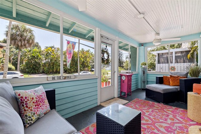 sunroom / solarium with a healthy amount of sunlight and ceiling fan