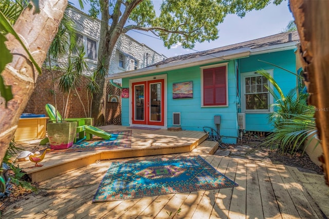 exterior space with a deck and french doors