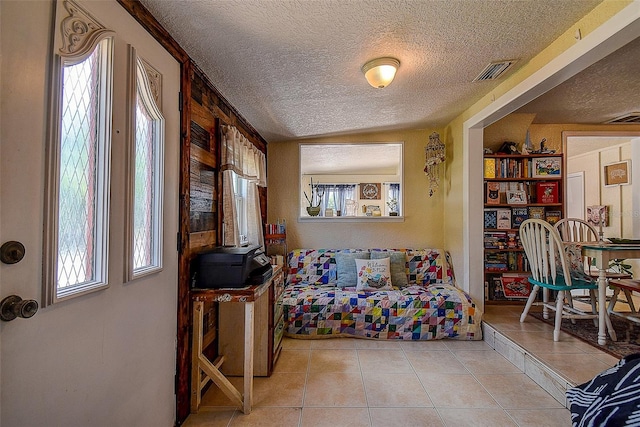 bedroom with light tile patterned floors and a textured ceiling