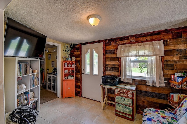 home office featuring light tile patterned flooring and a textured ceiling