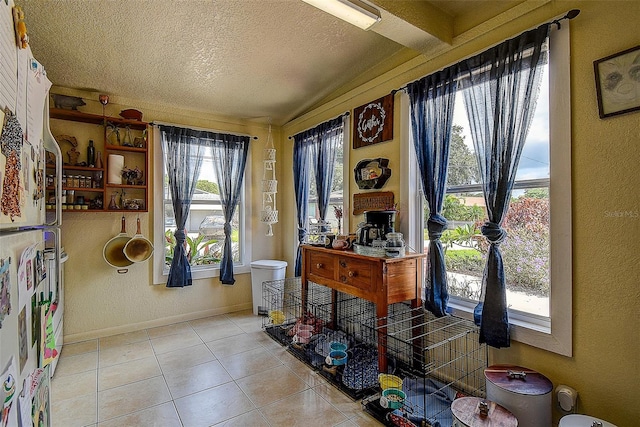 tiled foyer with a textured ceiling