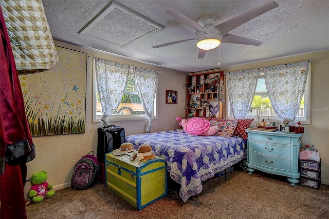 bedroom with ceiling fan, carpet flooring, and a textured ceiling