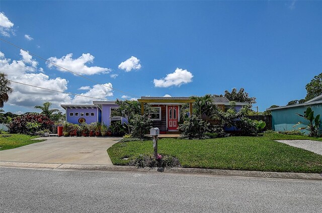 view of front of property with a front yard and a garage