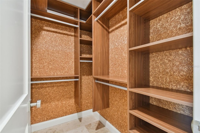 spacious closet with tile patterned floors