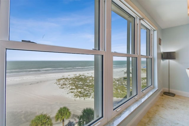 interior space featuring a water view and a beach view