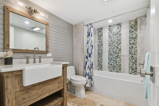 full bathroom featuring vanity, shower / bath combination with curtain, toilet, and wood walls