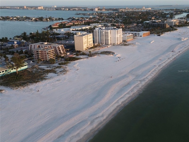 birds eye view of property with a water view and a view of the beach