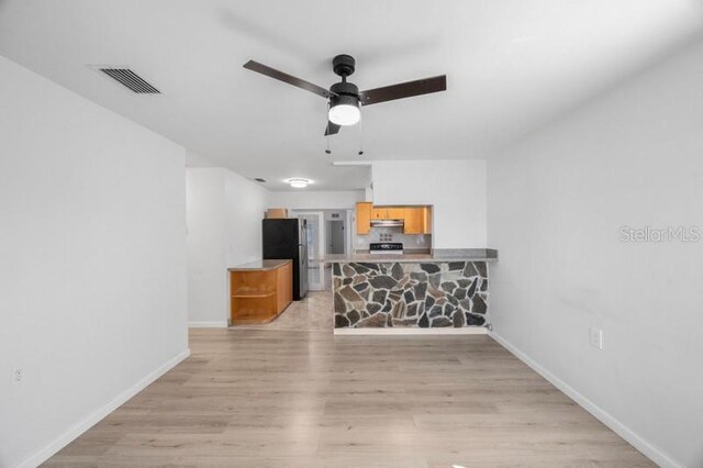 living room with light wood-type flooring and ceiling fan