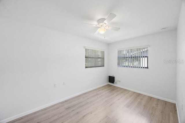 unfurnished room featuring light hardwood / wood-style flooring and ceiling fan