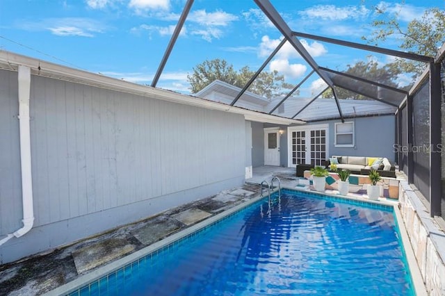 view of swimming pool featuring an outdoor living space, a lanai, and a patio