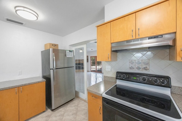 kitchen with backsplash, range with electric cooktop, stainless steel refrigerator, and light tile patterned flooring