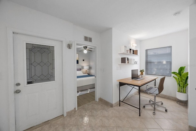 tiled home office featuring ceiling fan