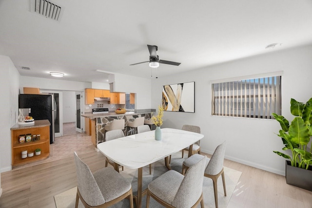 dining area featuring ceiling fan and light hardwood / wood-style floors