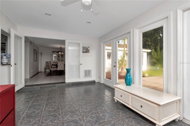 interior space featuring ceiling fan and french doors